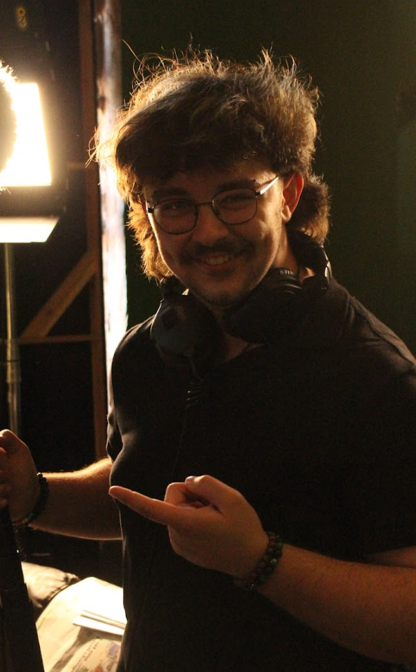 Chris Gray smiles at the camera whislt on a film set